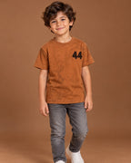 Rust Kids’ 44 Washed Graphic T-Shirt, child model front three-quarter view. T-shirt only.