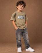Khaki Kids’ Flindall’s Star Graphic T-Shirt, child model front three-quarter view. T-shirt only.
