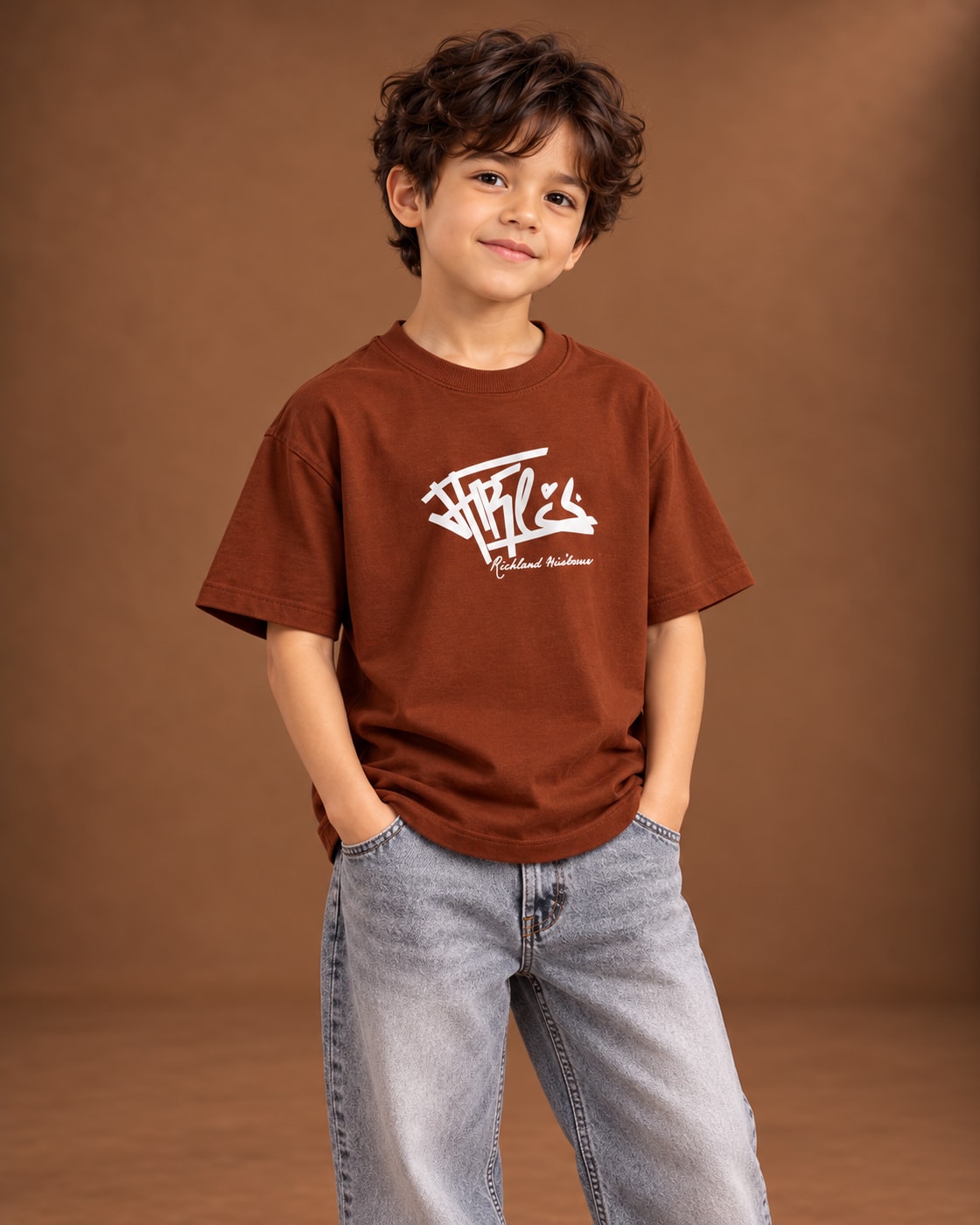 Brown Kids’ Richley Graffiti T-Shirt, child model front three-quarter view. T-shirt only.