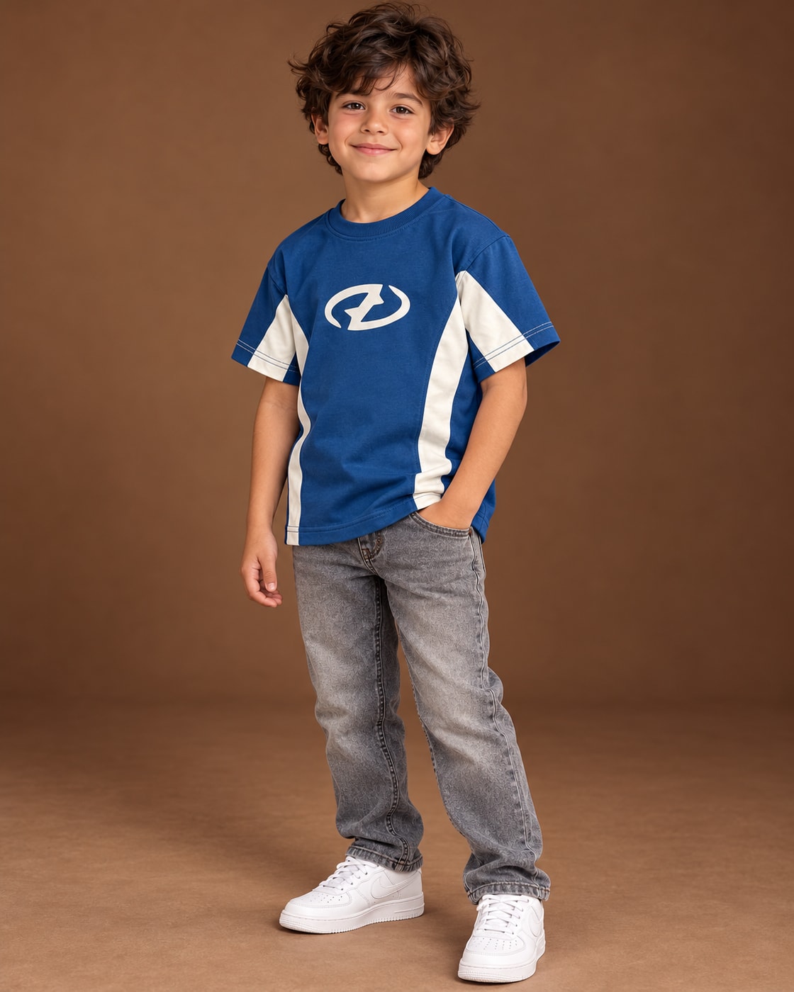 Blue / Cream Kids’ Unloose Colourblock T-Shirt, child model front three-quarter view. T-shirt only.