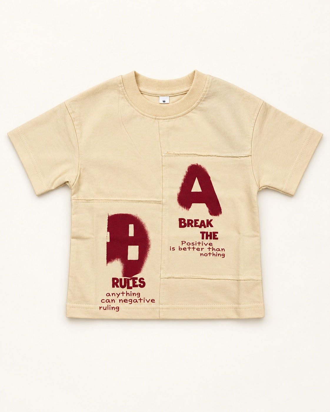 Front view of cream kids’ a/b graphic t-shirt.