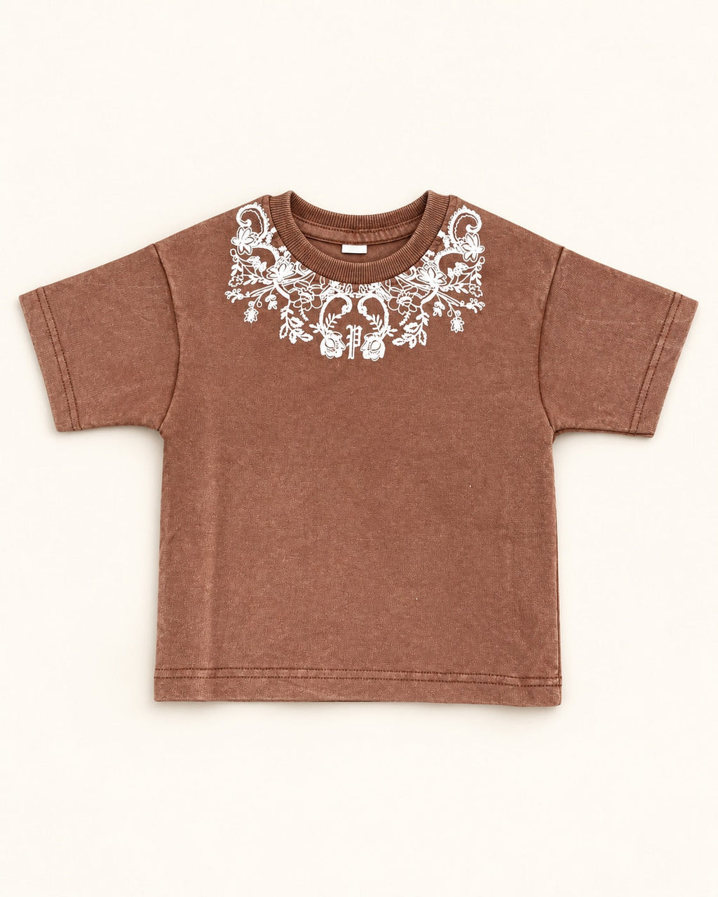 Front view of brown kids’ ornamental print t-shirt.