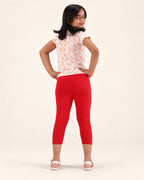 Rear view of girls’ red capri leggings.