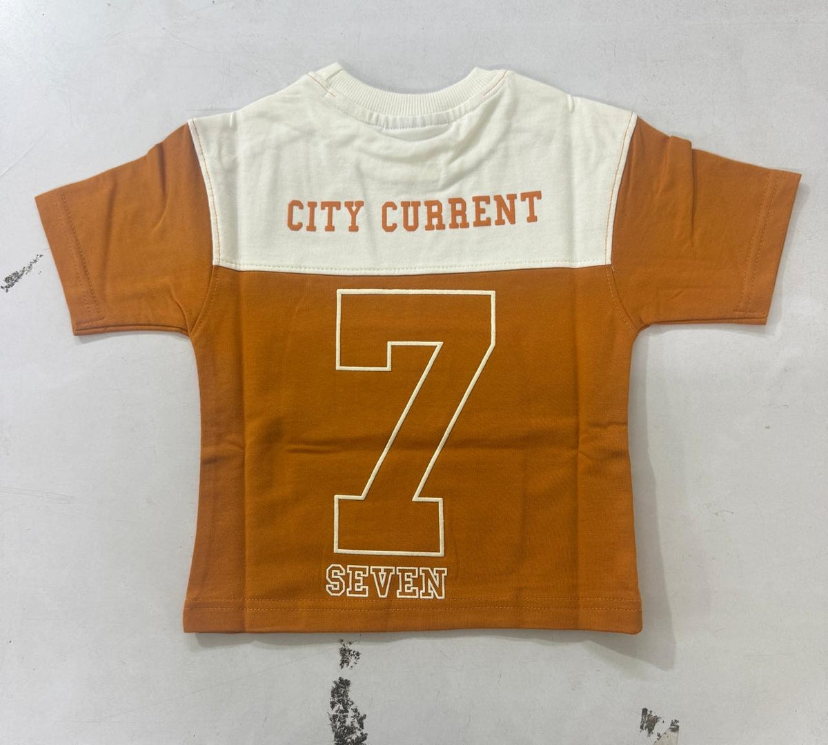 Mustard Kids’ City Current Seven T-Shirt, supplied back view.